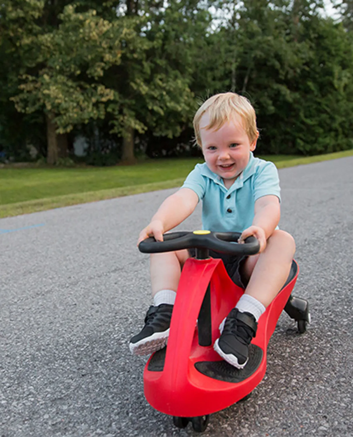 A toddler discovers the steering-driven propulsion that moves the car without pedals or batteries.