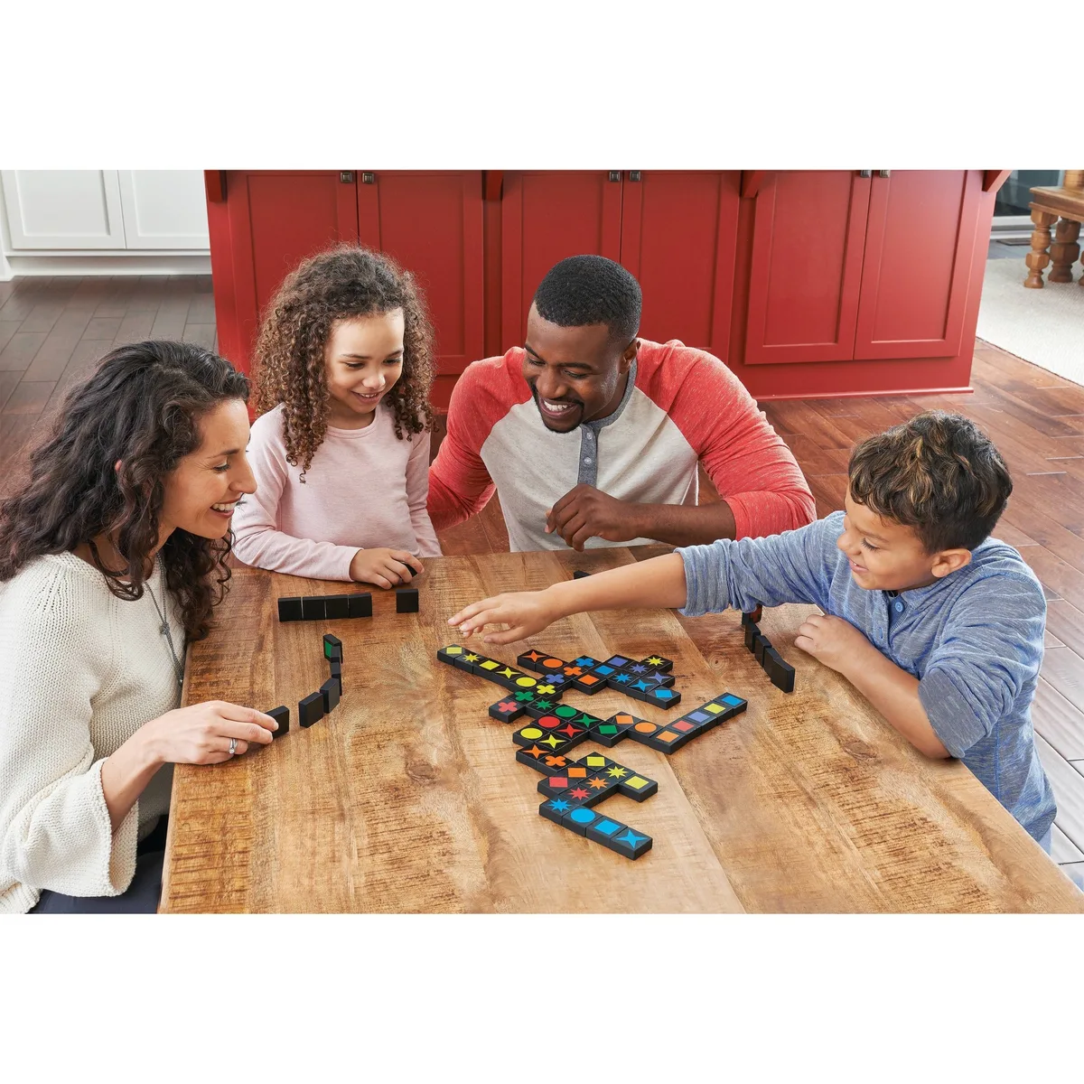 A family game stretches across the kitchen table, with grids growing outward in both dimensions.