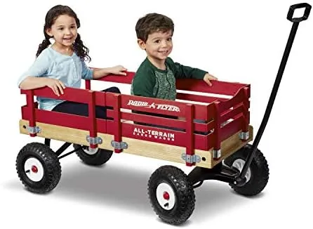 Two children ride together in the All-Terrain Cargo Wagon, side rails extended.