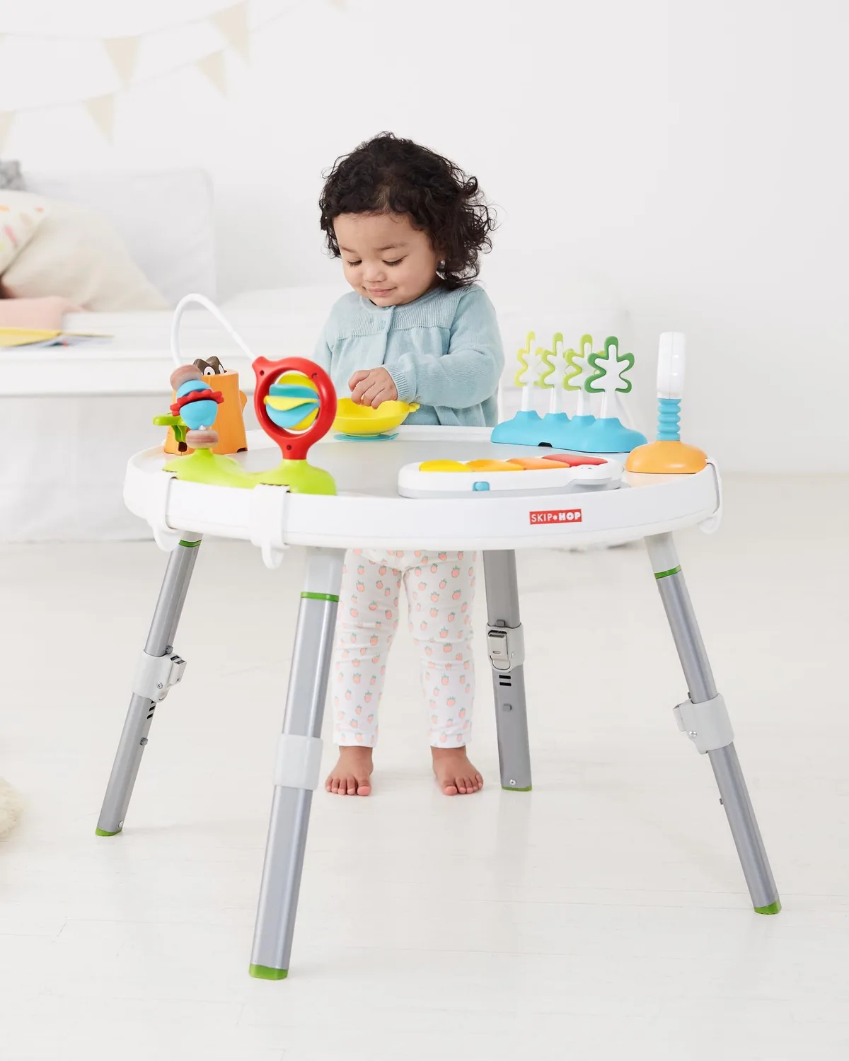 Removable activity panels travel between the seat tray and the converted play table.
