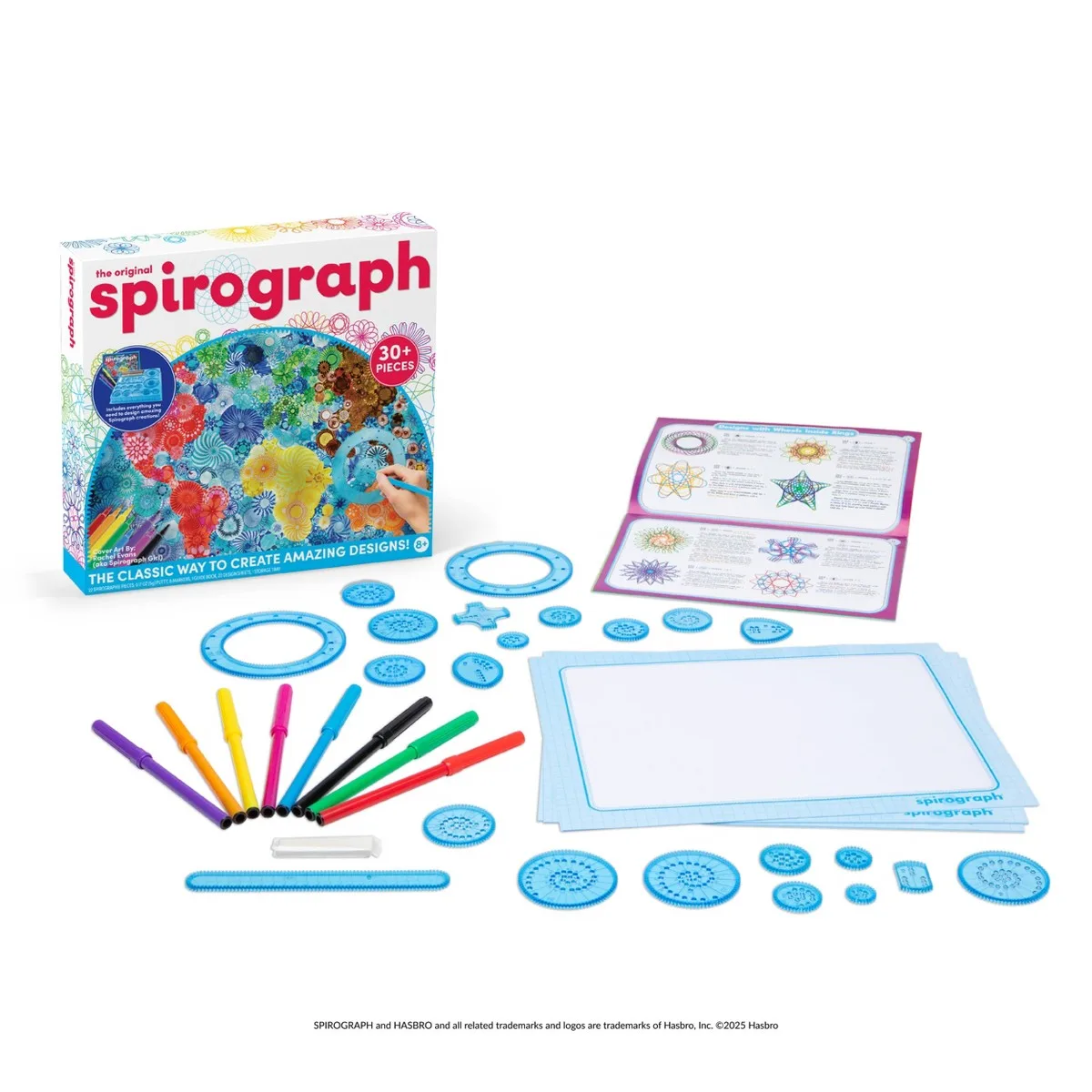 The complete kit laid out: gears, rings, pens, design guide, and paper pads — every component childr