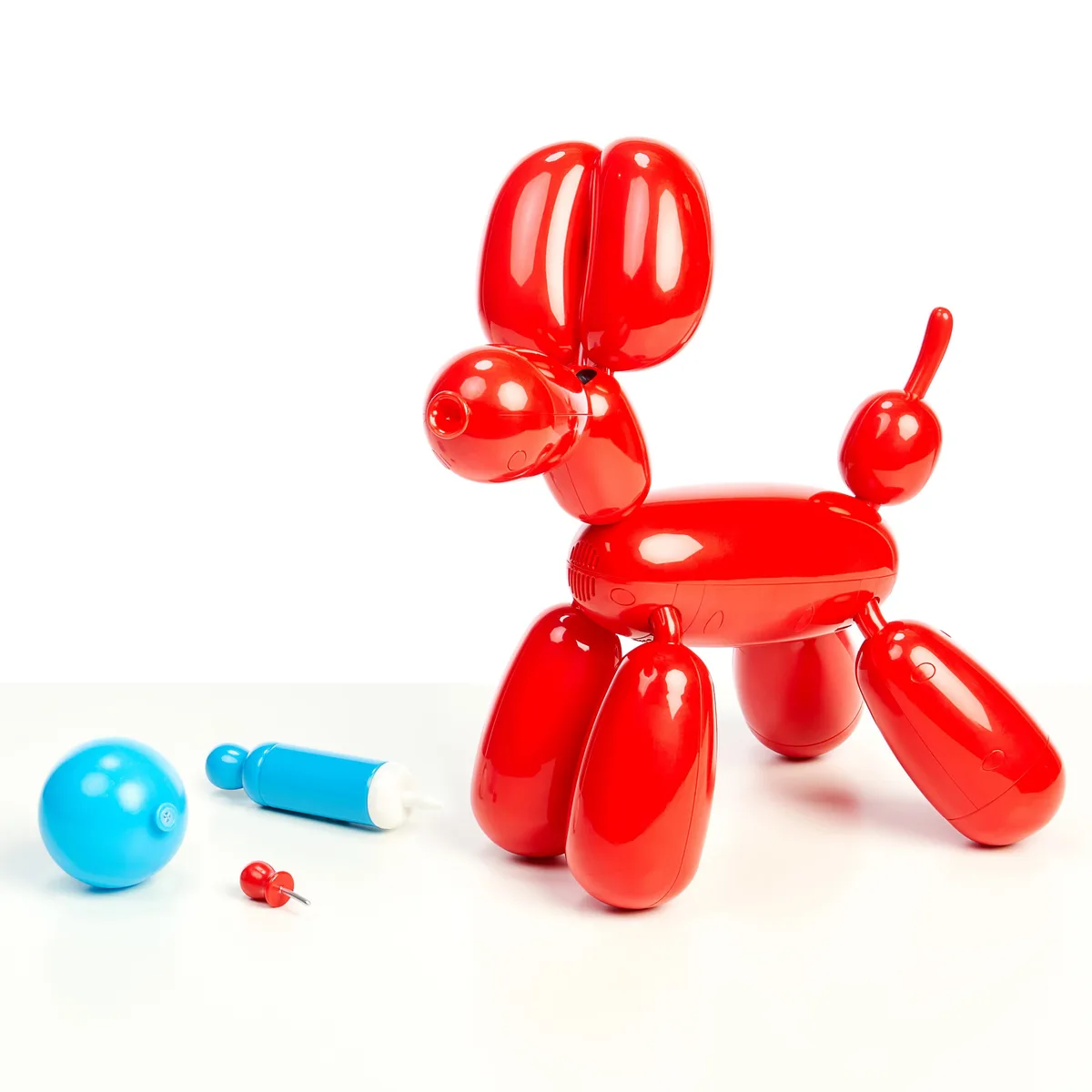 The balloon dog with its inflation pump and accessory ball, ready for interactive play.