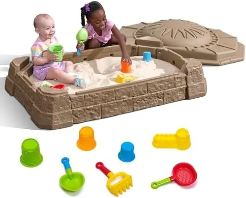 The sandbox arrives with seven molded accessories — buckets, scoops, a sifter, a rake.