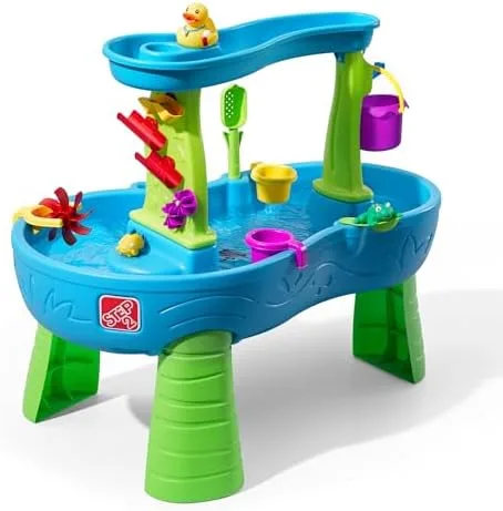 The Rain Showers Splash Pond stands roughly waist-high to a toddler, with a green spinner, ramps, an
