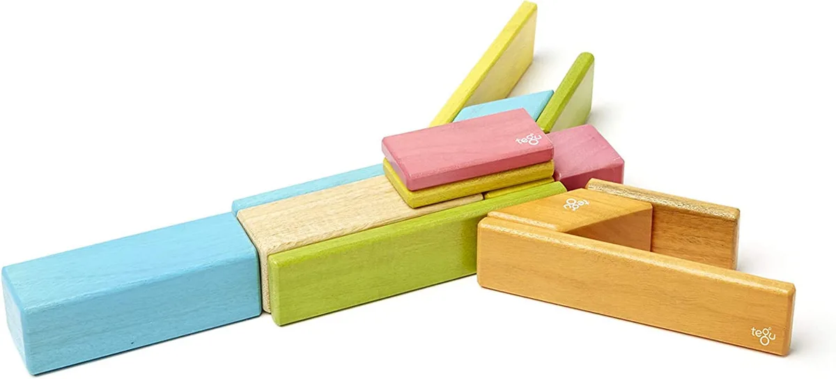 Tegu's Tints palette laid flat: hardwood grain shows through translucent stains in blue, green, pink