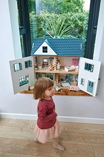 Wall-mounted on a shelf, the dollhouse shows how its design accommodates small-space living.