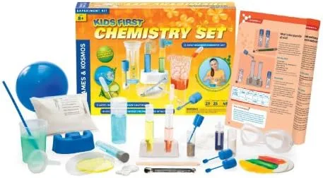 The full component spread: graduated cylinders, droppers, beakers, goggles, and the experiment manua