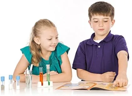 Two children working through a guided reaction together, the social structure that makes the kit wor