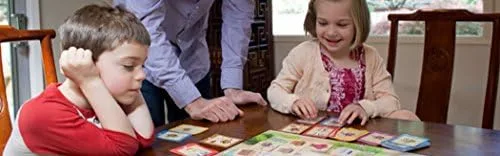 Two children navigate turtles across the grid while an adult facilitates, the intended cooperative l