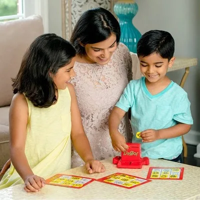 A parent and two children mid-round, the slider ka-chunking another tile into reach.