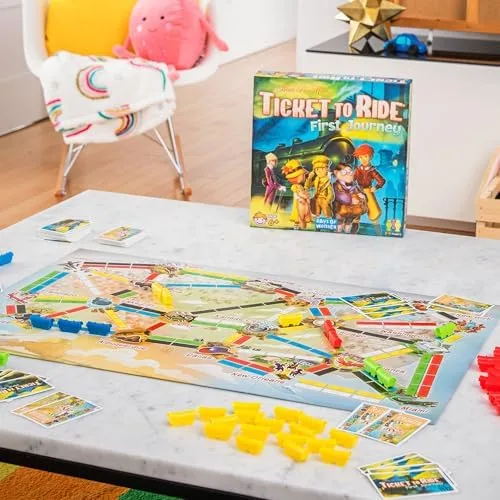 Mid-game on a kitchen table — yellow trains claim a route while spare cards wait their turn.