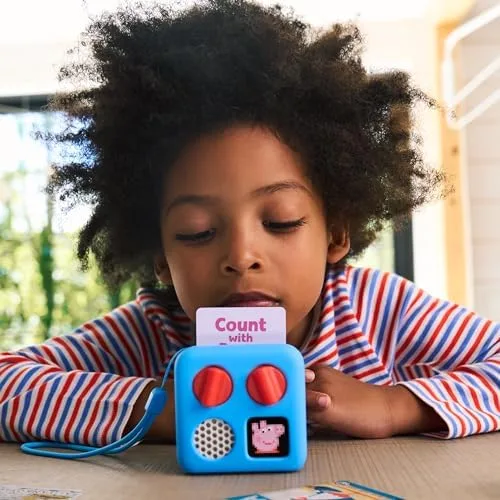 A child loads a story card into the blue Mini, controlling playback without a screen.