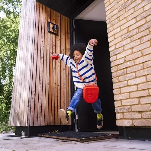 A child runs out a doorway with the Mini swinging on its lanyard, audio in tow.